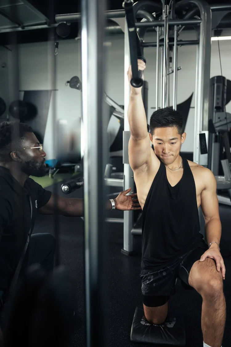 Half-kneeling lat pulldown form coaching at Crown Fitness personal training in Irvine, CA