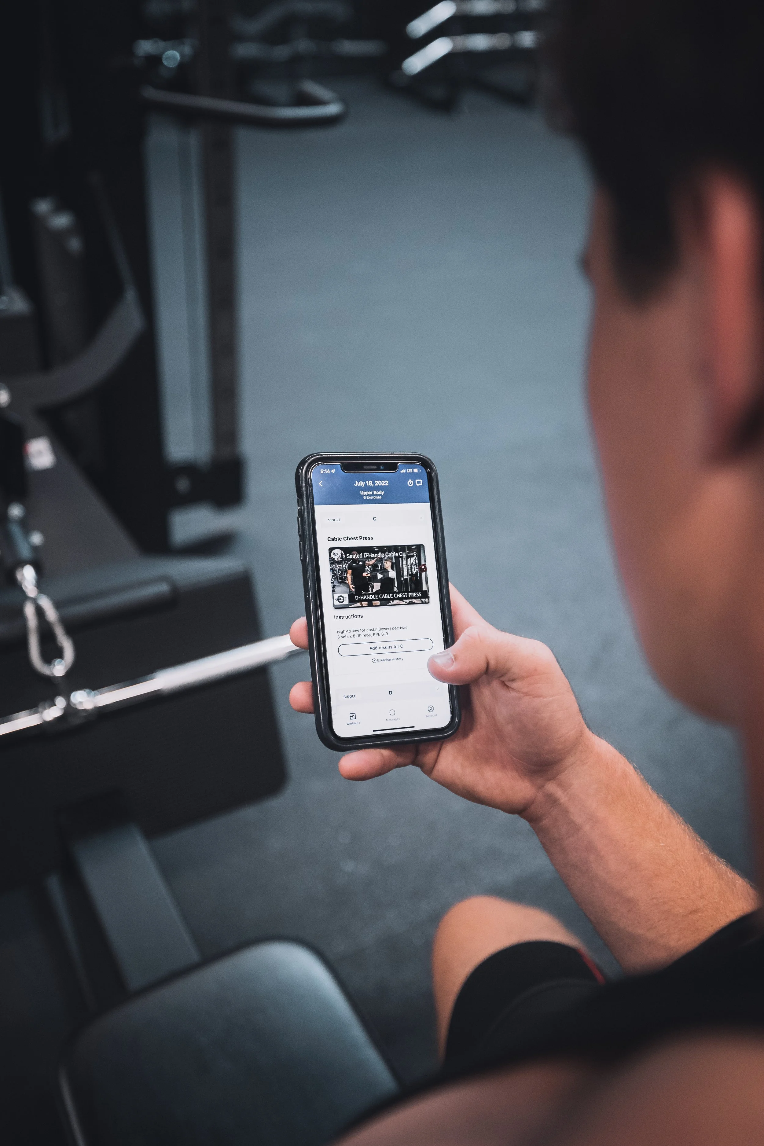 Client using the Crown Fitness app for guided workout instructions during a personal training session in Irvine. Accessible and personalized fitness coaching for Newport Beach, Corona del Mar, Tustin, Huntington Beach, and all of Orange County.