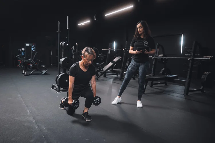 Personal trainer coaching strength training at Crown Fitness in Irvine, CA