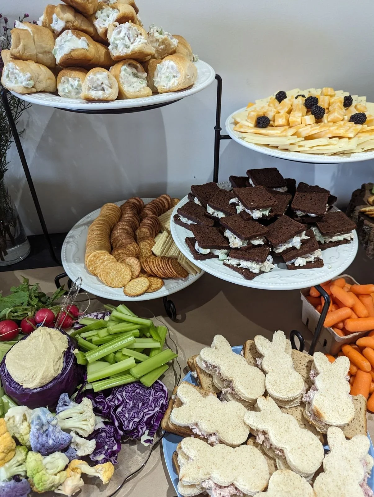 Spring themed lunch with bunny shaped sandwiches, chicken salad cream puffs and a vegetable display at Wildflower Estate