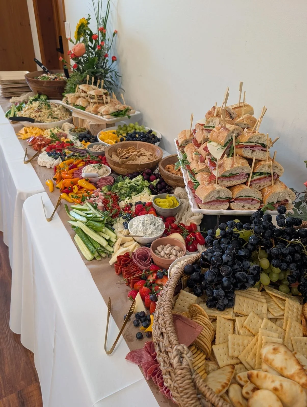Elevated grazing lunch with artisan ciabatta sandwiches, grazing display and fresh flowers at Wildflower Estate