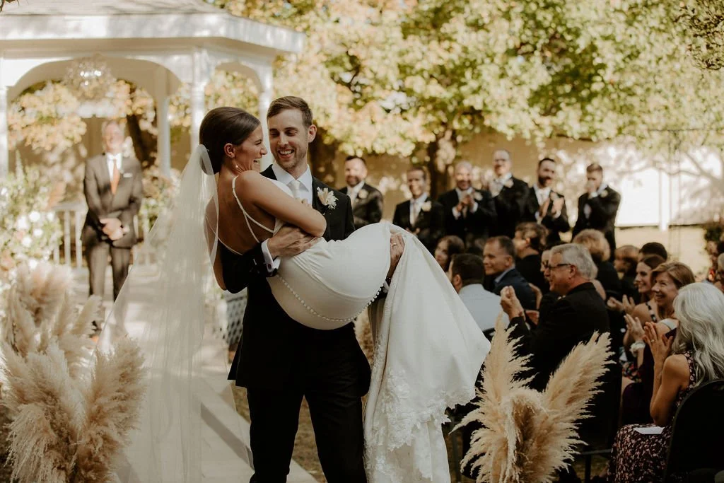 Newlyweds leaving their ceremony at Holland Gardens