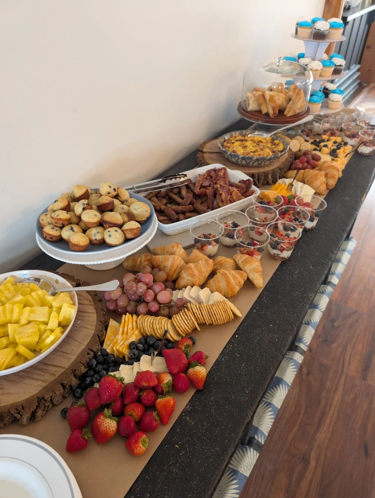 Brunch spread with muffins, bacon, egg bake, parfaits and fruit at a Wildflower Estate shower
