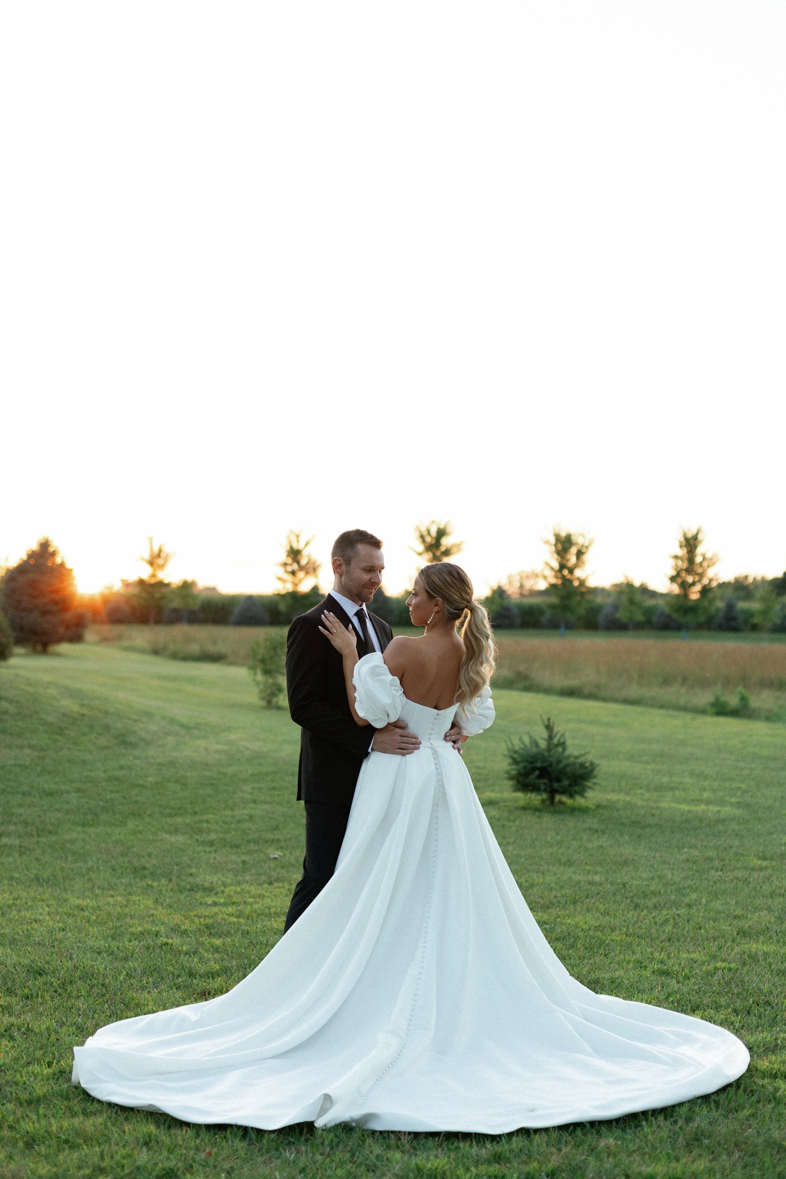 A couple at sunset on the field at Wildflower Estate