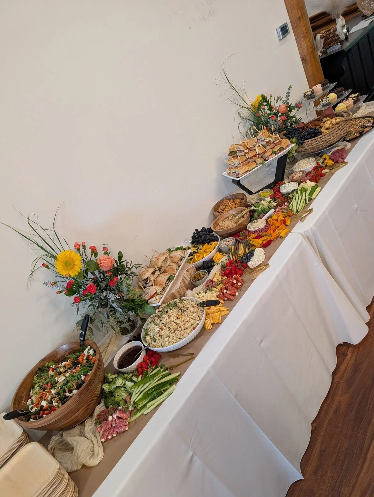 Full lunch spread with orzo salad, berry and goat cheese salad, artisan sandwiches and dessert display at Wildflower Estate