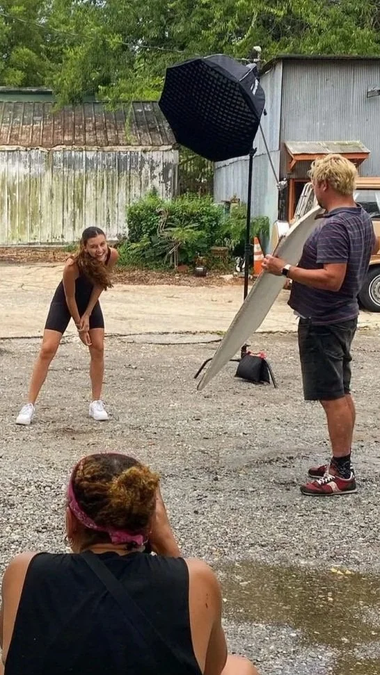 Photographer directing talent with emotional intelligence during commercial photo shoot. Strong creative leadership on set allows authentic moments to unfold.