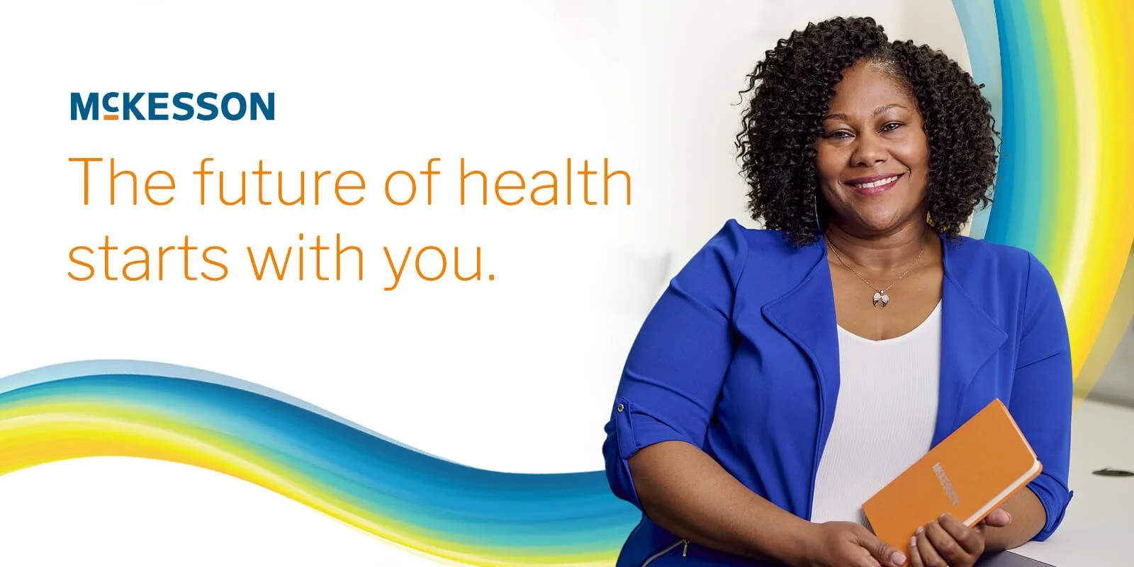 A woman with curly black hair, wearing a blue blazer and white top, smiling and holding an orange notebook. Background features colorful rainbow-like swirls and a message that reads, "The future of health starts with you" for MeKesson.
