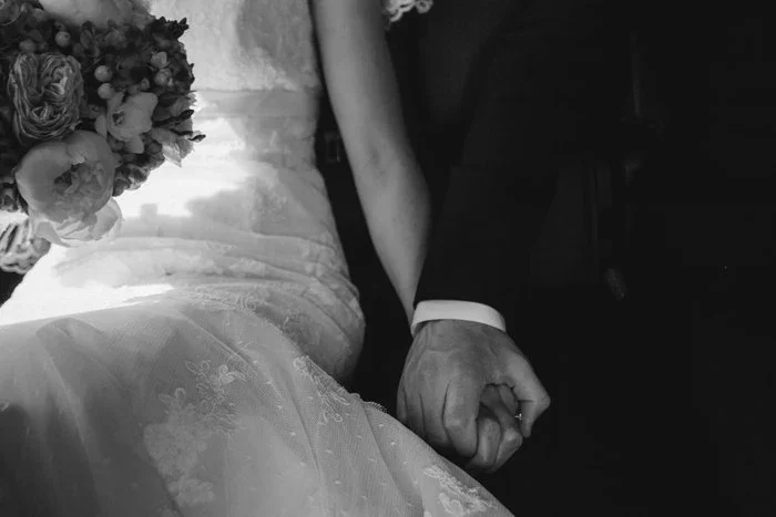 bride and groom holds hands.webp