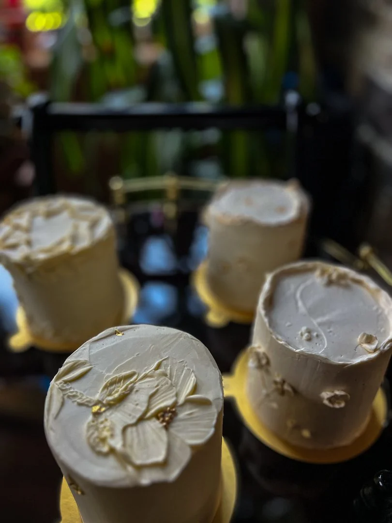 Mini wedding tasting cakes with neutral buttercream, textured finish, and gold leaf accents on gold cake boards, Grand Rapids, MI