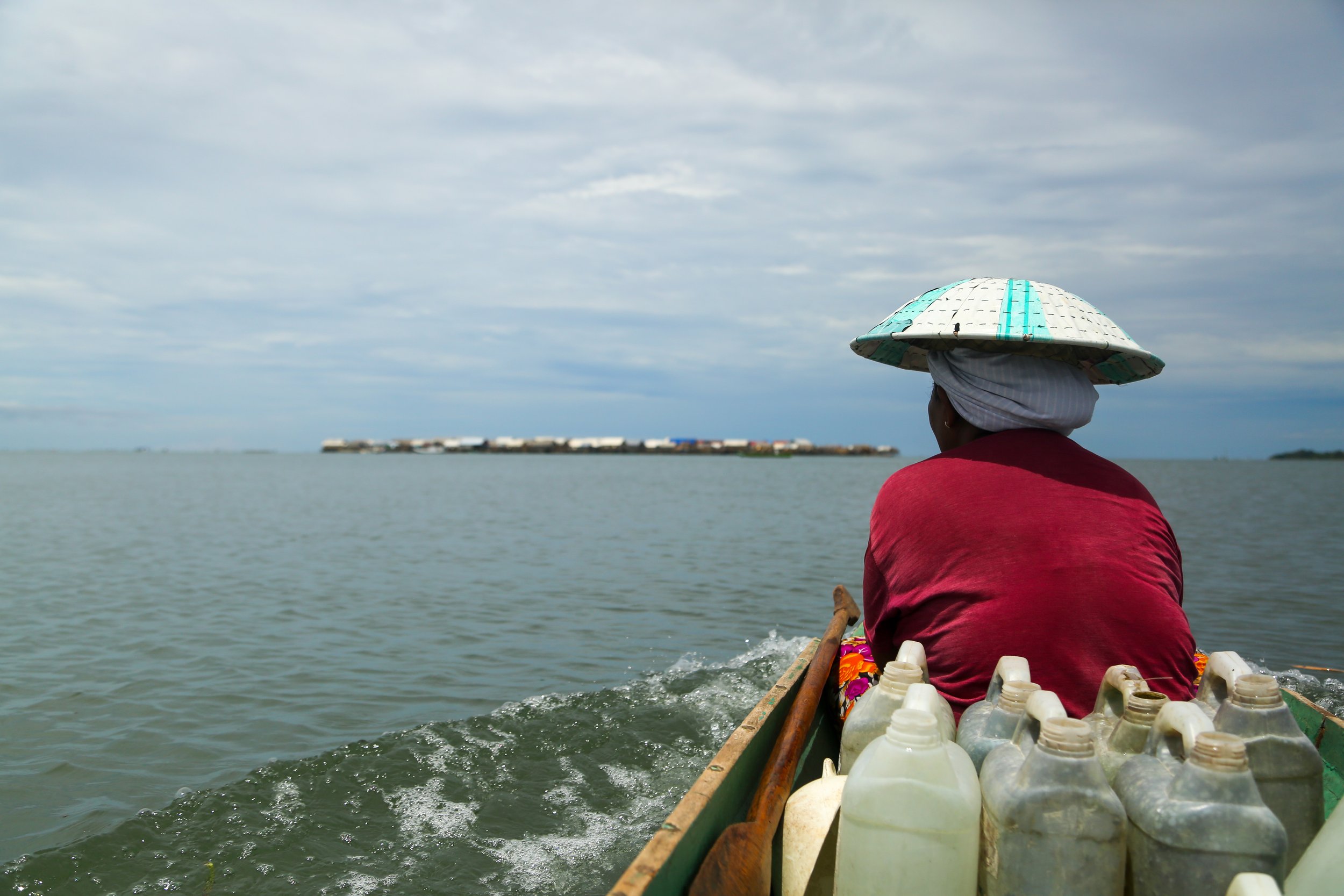 Bringing water for drinking, washing, and cooking back to the village from land, Sampela, Sulawesi.