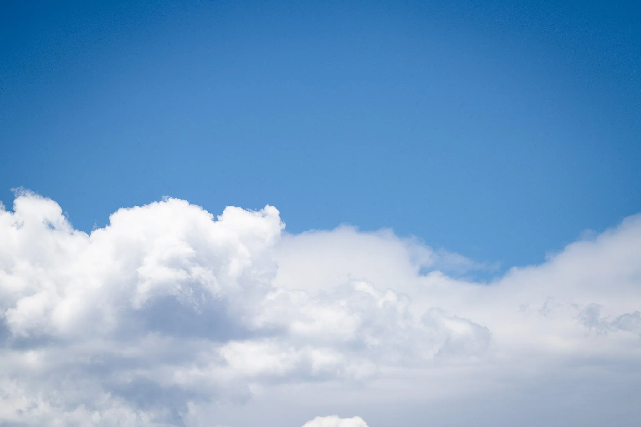 Blue sky with white, fluffy clouds.
