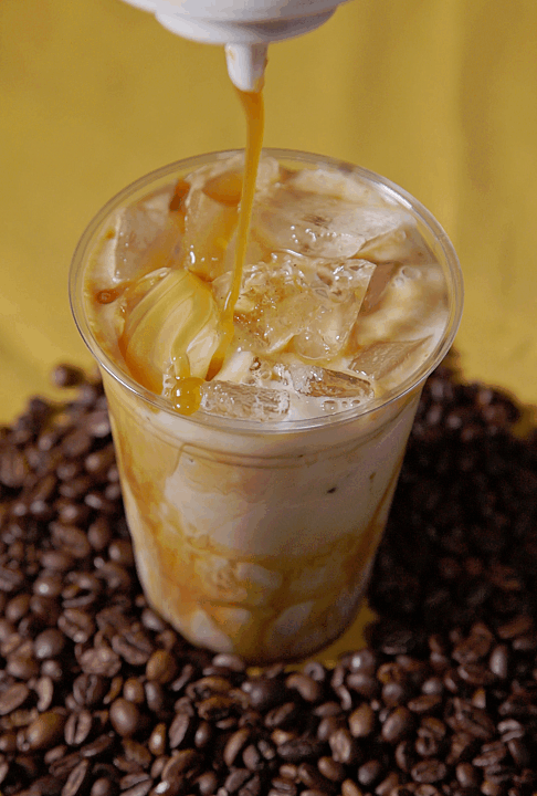 Caramel being drizzled onto an iced coffee