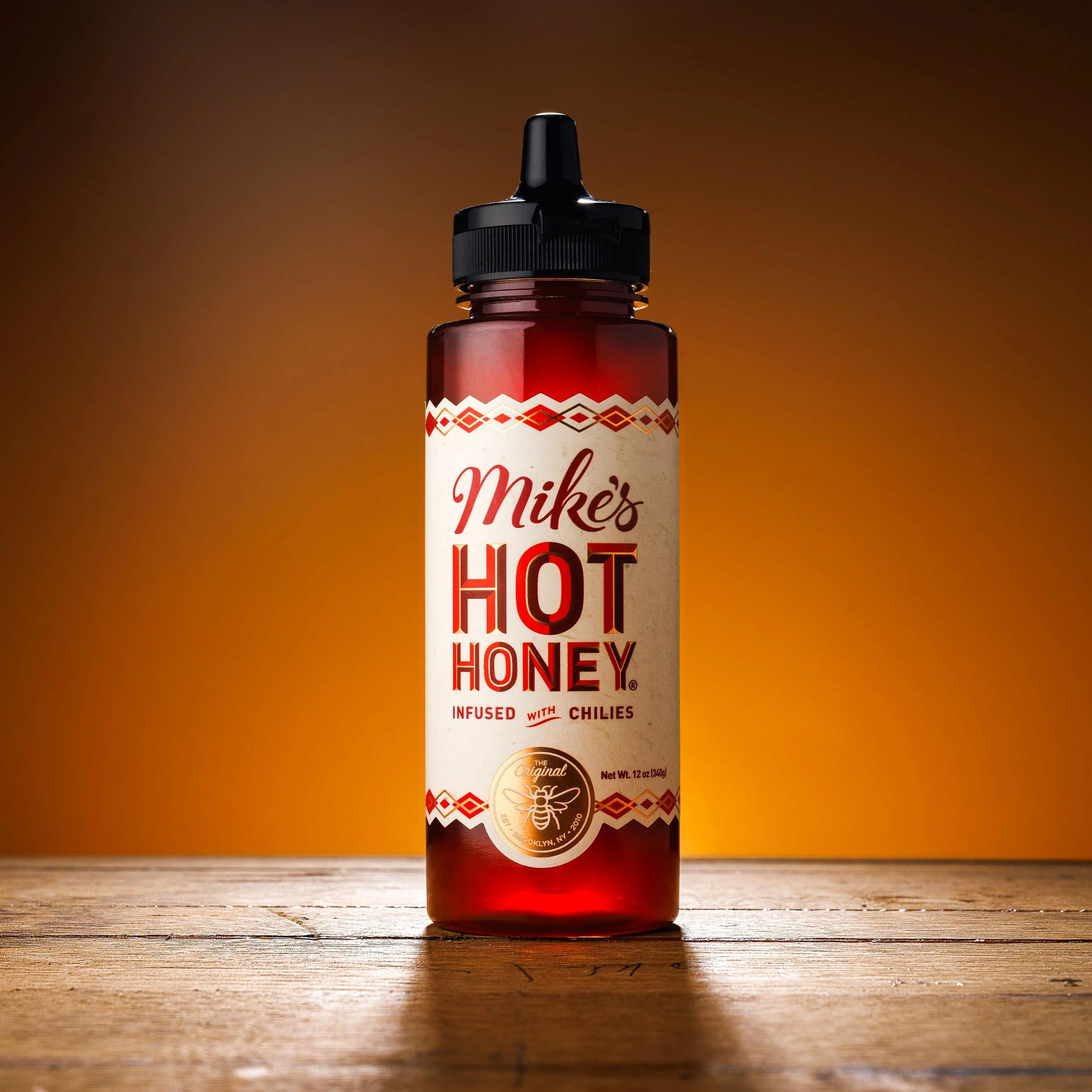 Product Photo of Mikes Hot Honey on a wood background
