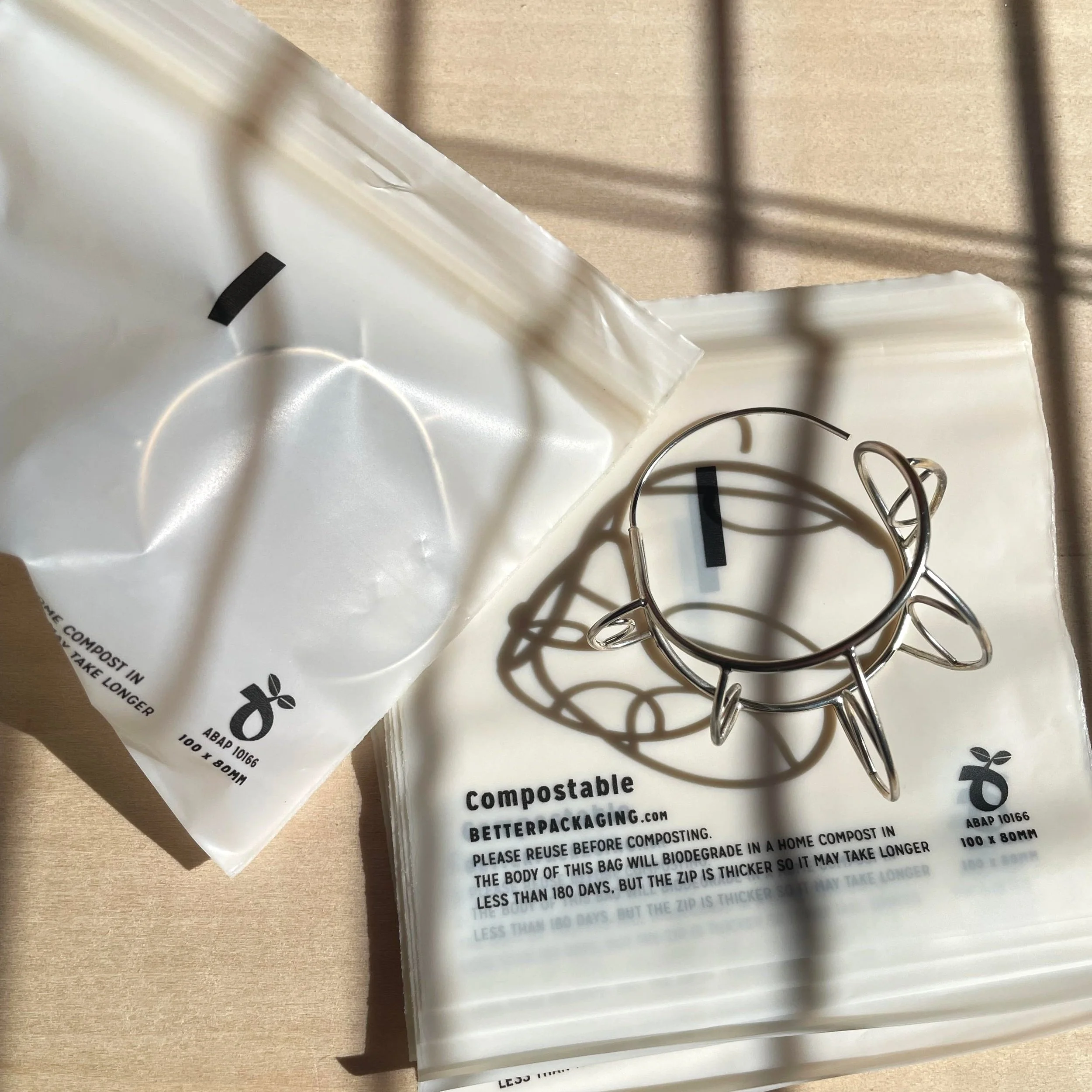  Large silver hoops sitting on their compostable baggies 