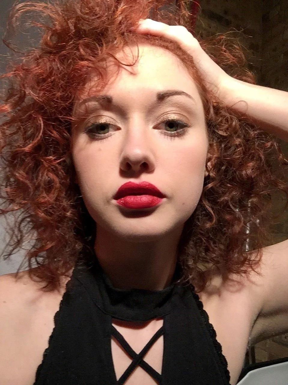 A girl with red curly hair and green eyes I pintura highlights I balayage I curly hair specialist Chicago