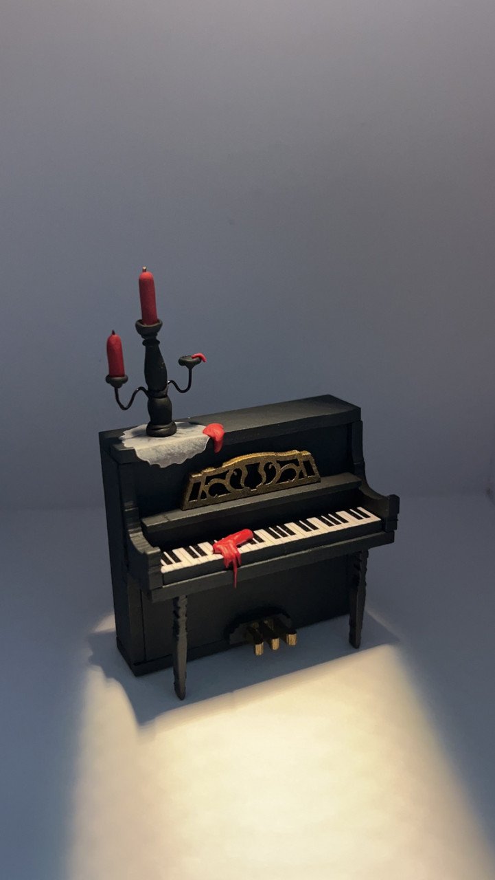 "Black, white, and red all over" By Allison Rahaman, Wood and clay; 3x3 inches; 2024