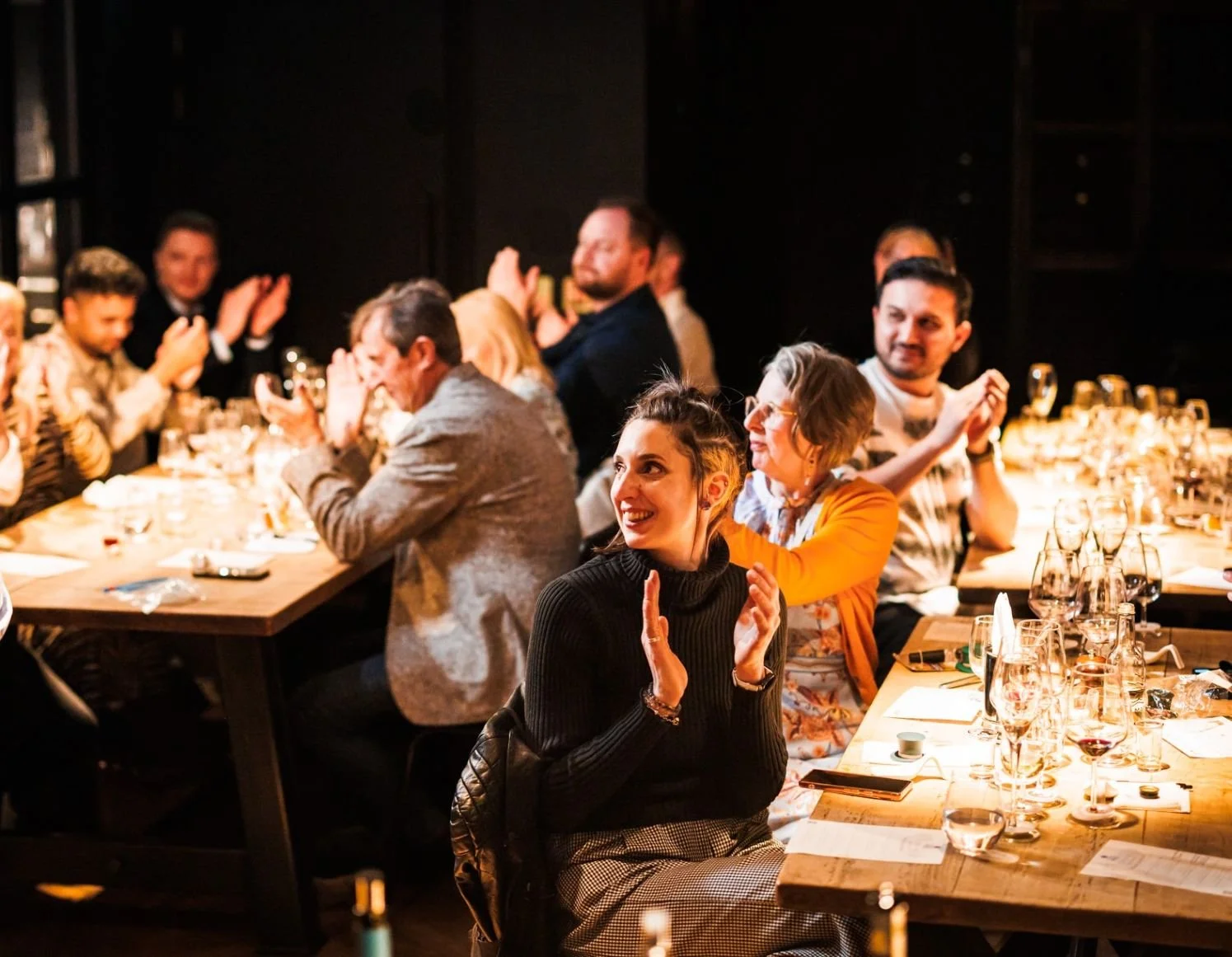 Guests enjoying an immersive, storytelling-driven corporate wine hospitality event with Colby Wines, showcasing an atmospheric dining table setup