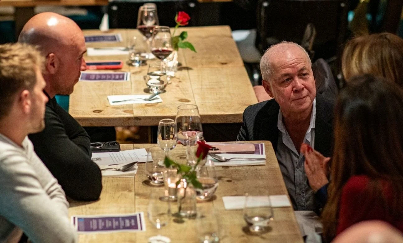 host from colby wines listens to a guest with wine questions