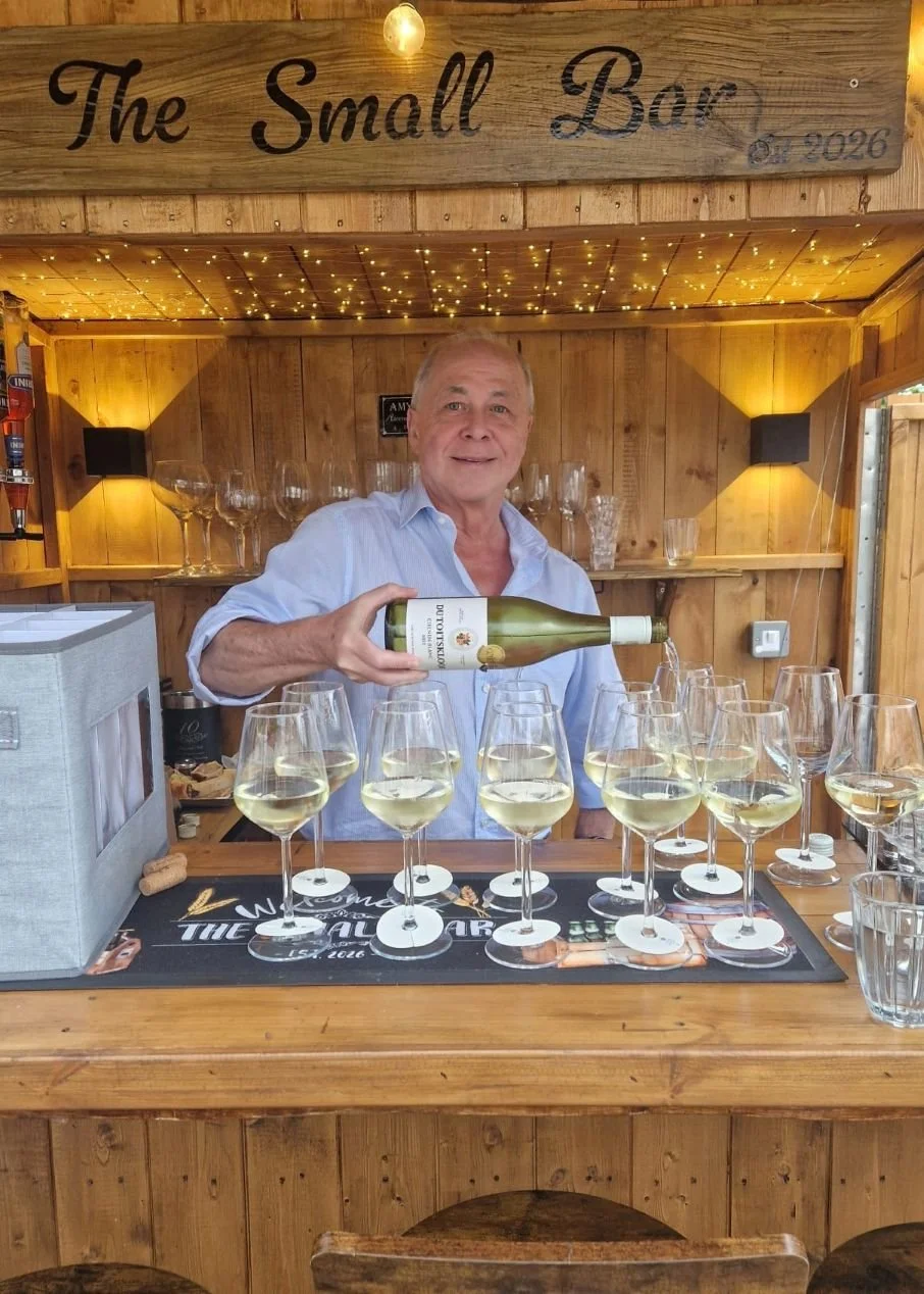 Professional Wine Host pouring wine for an at-home garden wine tasting experience by Colby Wines in Liverpool.