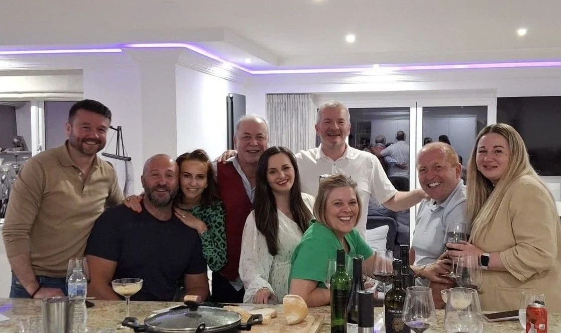 a group of friends gather in the kitchen after a colby wines tasting