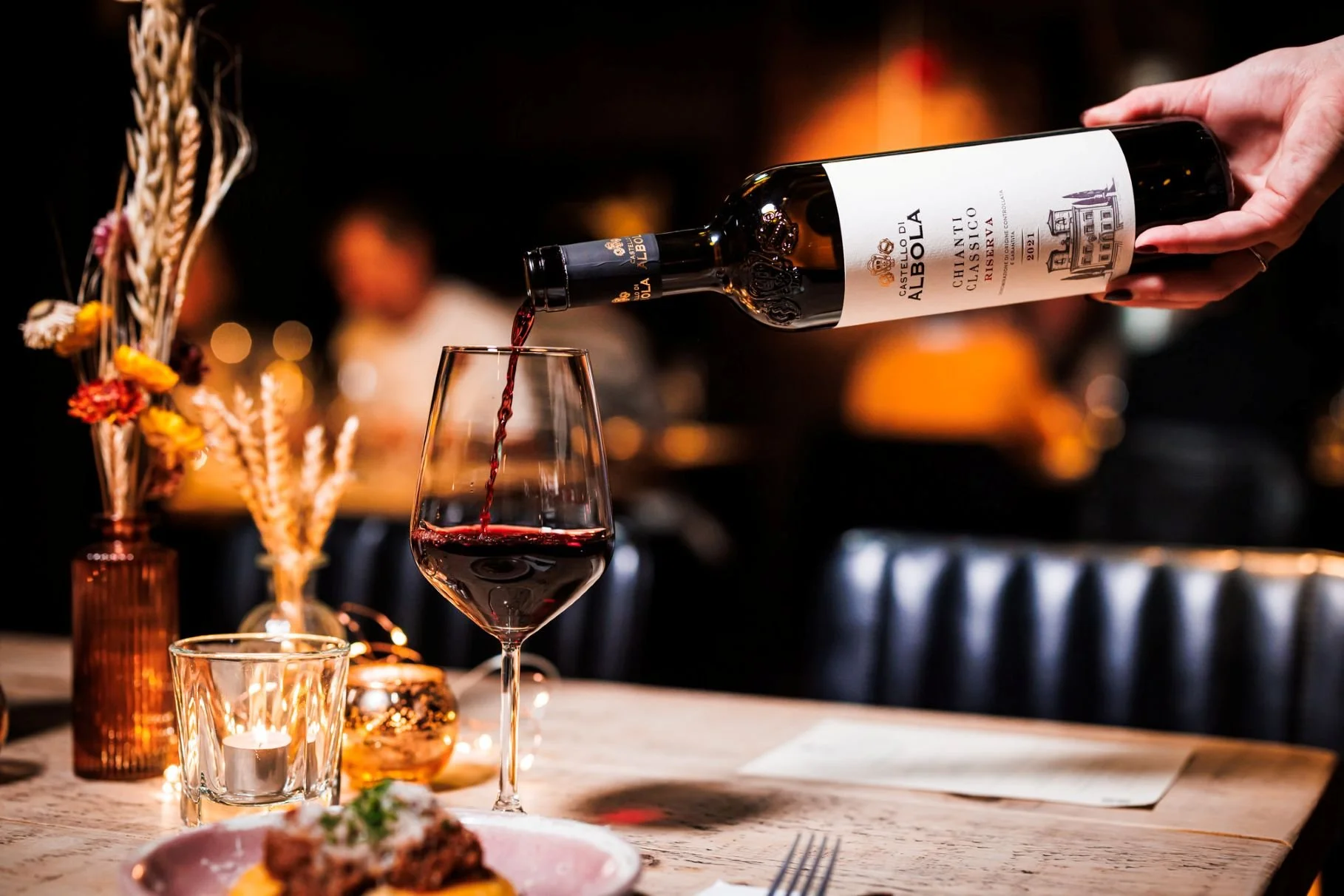 bottle of chianti classico being poured at a colby wines tasting in liverpool