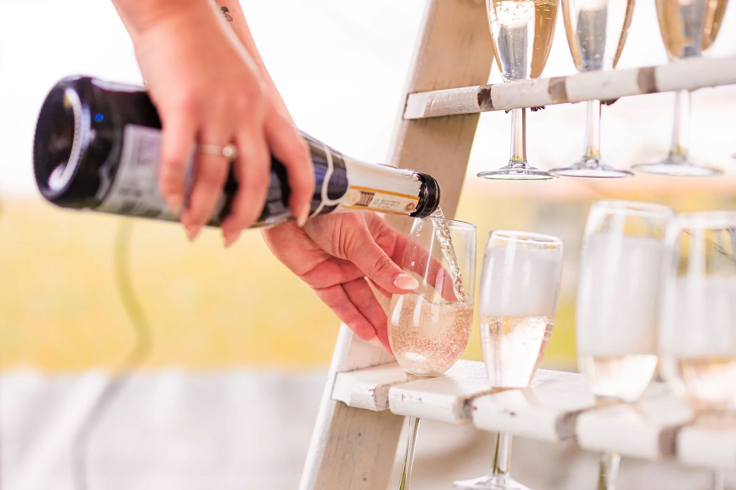 A close-up of champagne being poured into elegant glassware for a luxury wedding wine service across North West England, including Cheshire and Liverpool.