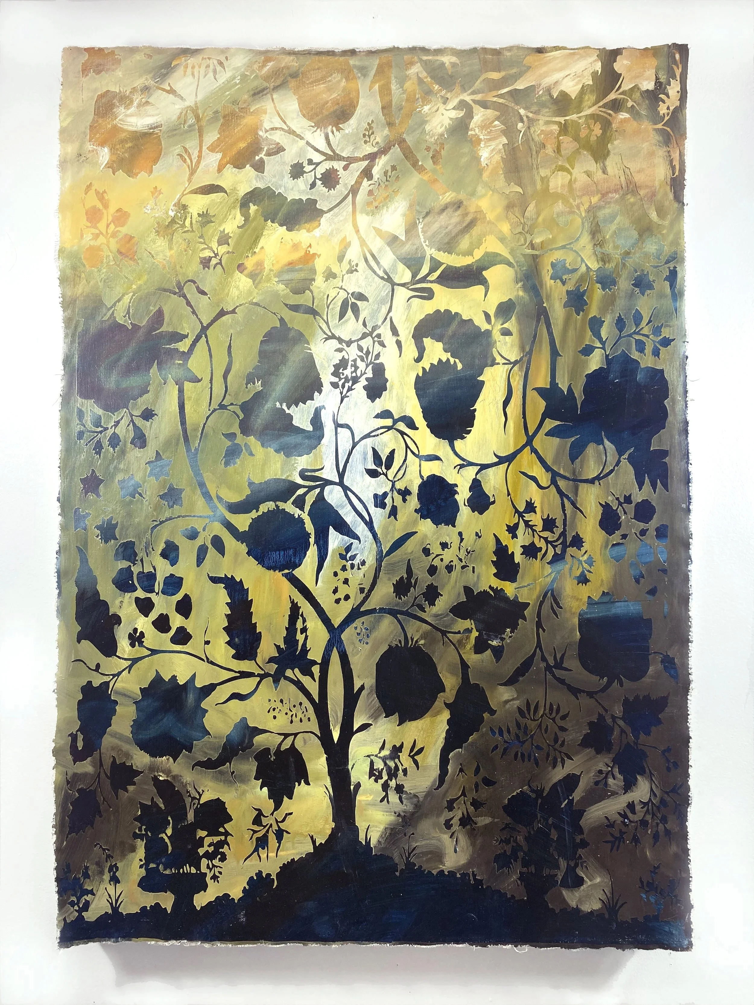 A metallic sheet with intricate black floral and leafy cutout patterns, set against a golden background.