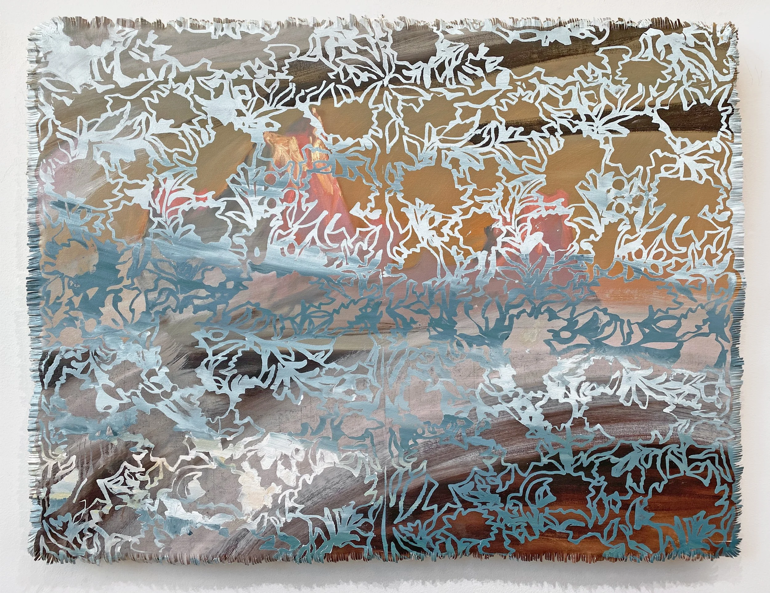 Metal wall art with intricate cut-out floral and leaf patterns, mounted on a wooden surface.