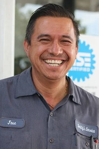 Smiling man in uniform with name tag 'Jose' and logo in background