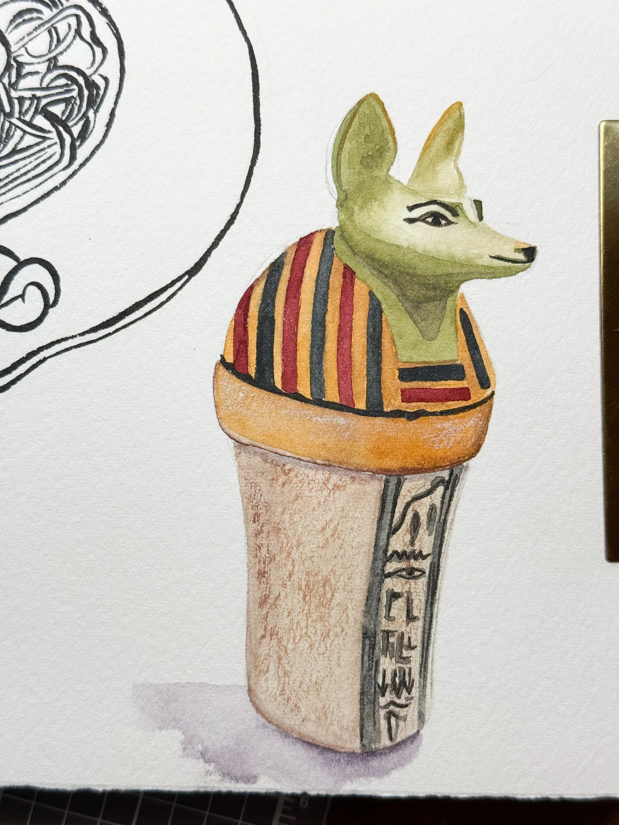 Watercolor drawing of a card with a fox face wearing a striped shirt, part of a Rubik's cube, and stylized hieroglyphic-like symbols.