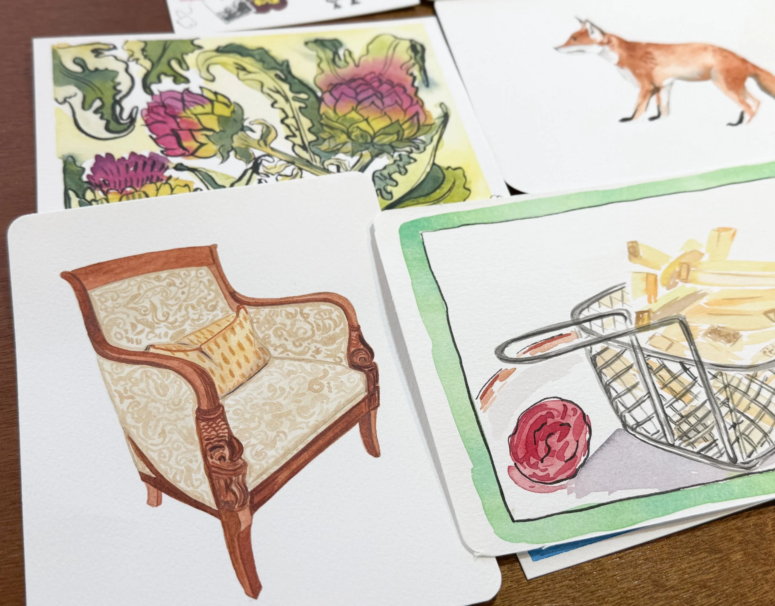 A collection of watercolor illustrations including a floral design, a fox, a vintage sofa, and a shopping basket with yarn and knitting needles.