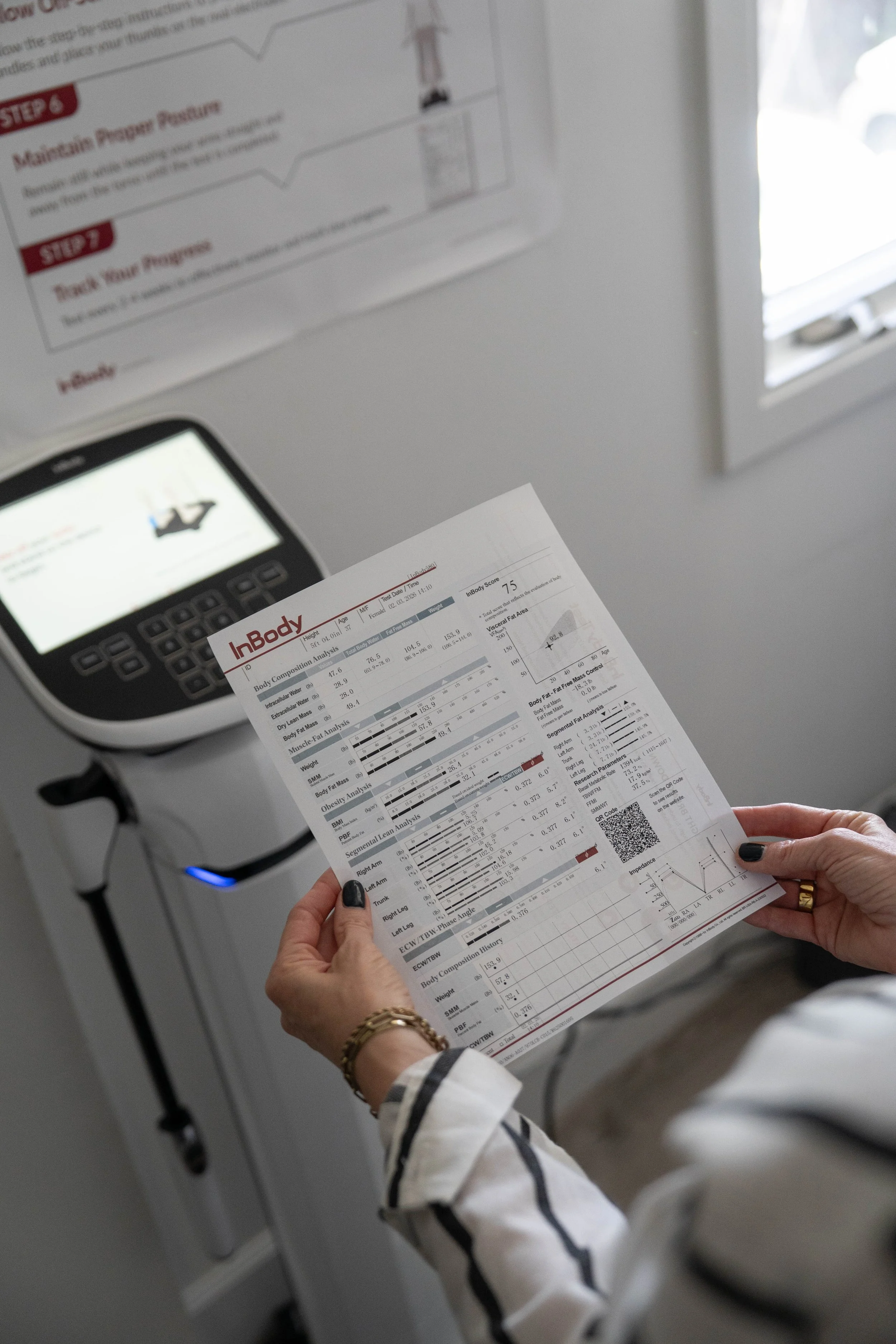 Person holding body composition analysis for tailored GLP-1 medical weight loss care.