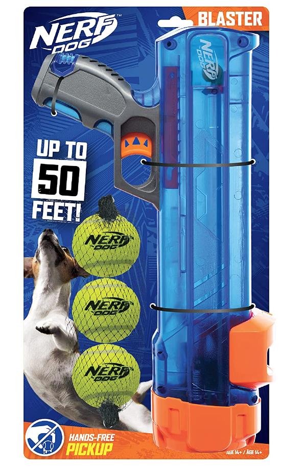 Nerf Dog Blaster toy set packaging showing a toy gun, three Nerf balls, and a dog, with text indicating it can shoot up to 50 feet and is for hands-free pickup for dogs aged 14 and older.