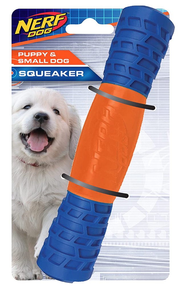 Packaging for Nerf Dog squeaker toy designed for puppies and small dogs. The toy has a cylindrical shape with a blue textured grip and an orange middle section. A happy white puppy is pictured on the packaging.