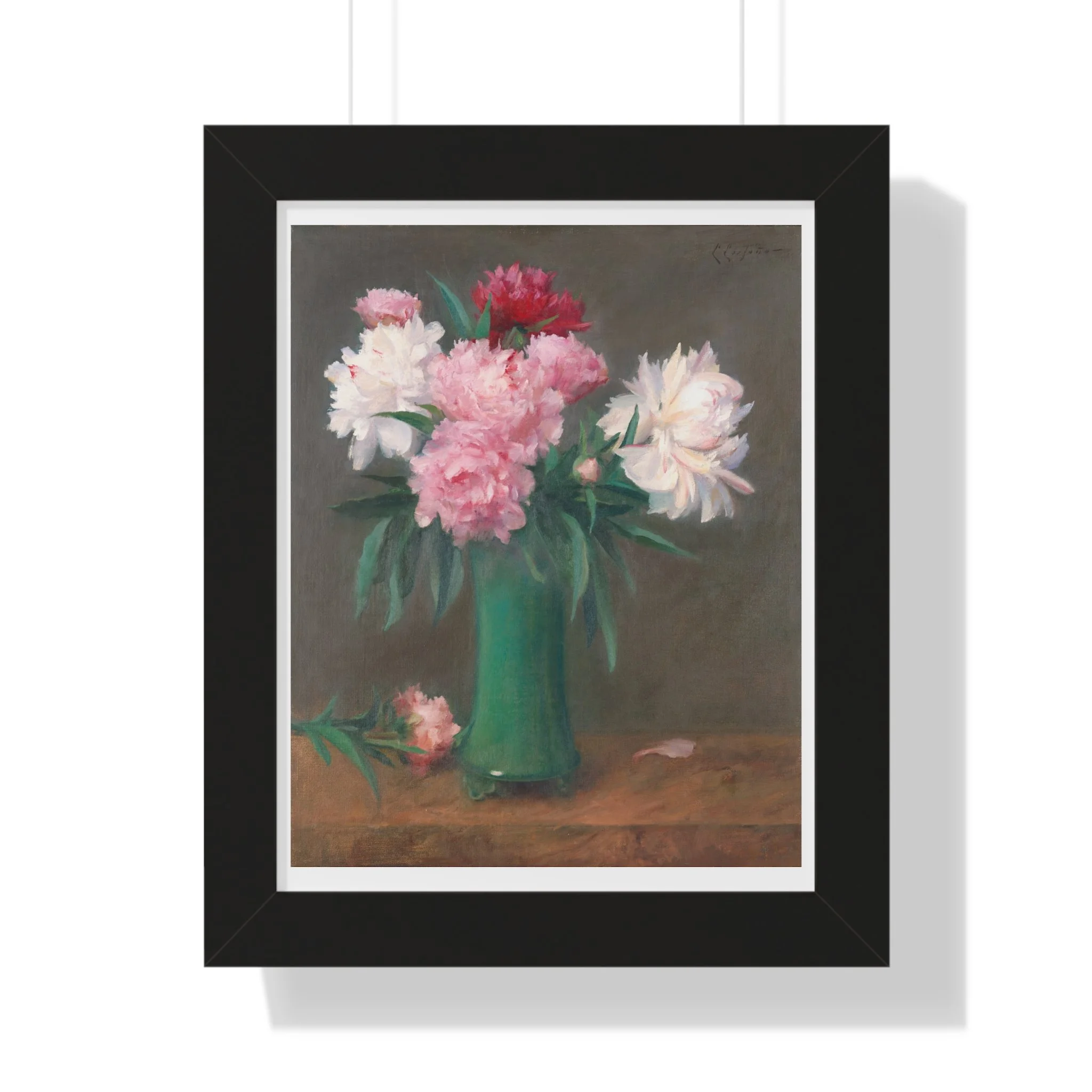 Fine art print of pink and white peonies in a green vase with soft lighting and muted background in black frame