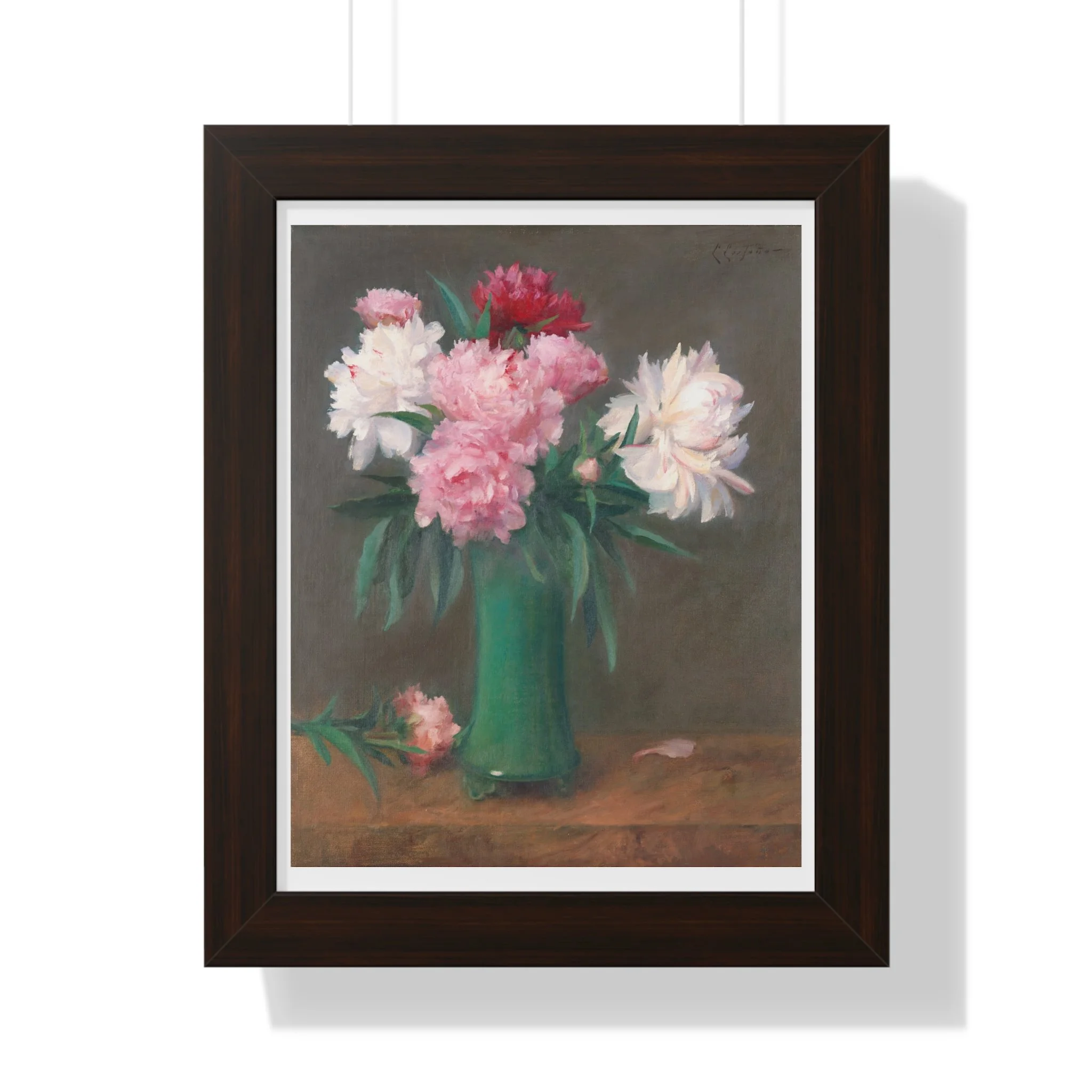 Fine art print of pink and white peonies in a green vase with soft lighting and muted background in black frame