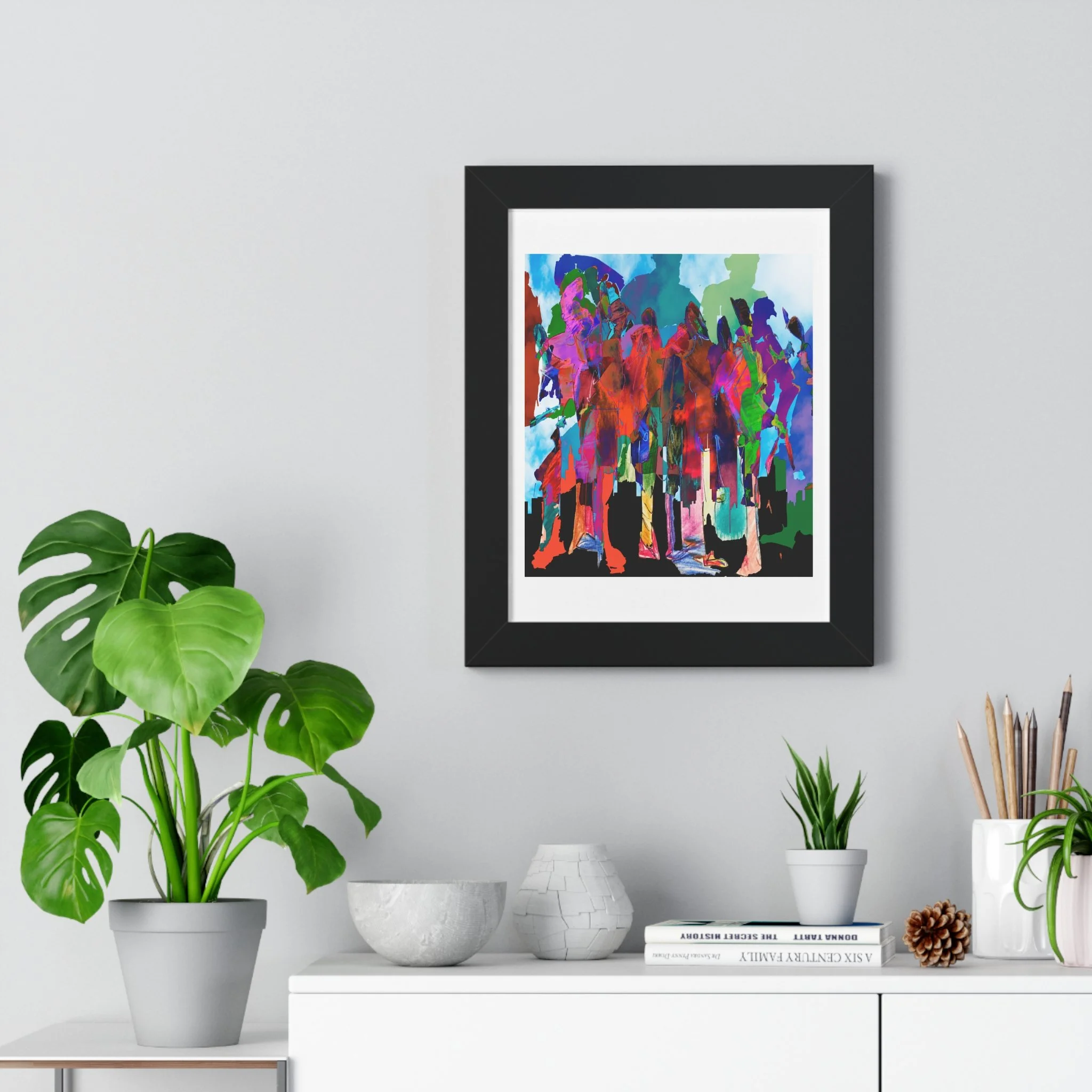 Mixed media digital artwork of colorful overlapping human figures standing above a black city skyline, rendered in vivid red, pink, teal, blue, green, and purple against a pale sky.