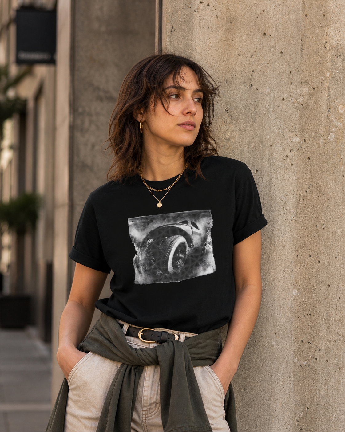 Female model wearing monochrome automotive wheel art graphic on black t-shirt