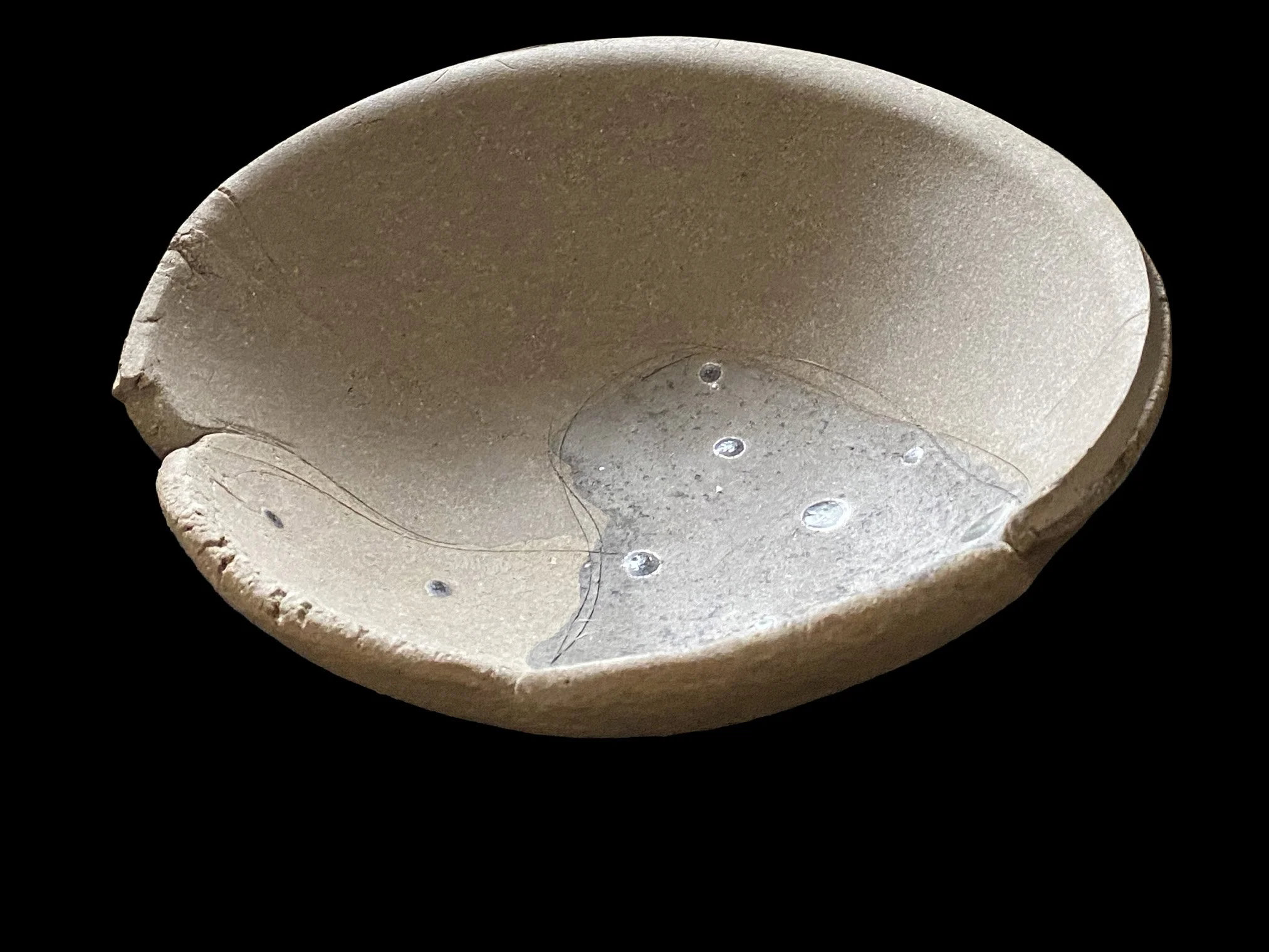Large yakishime unglazed stoneware bowl with organic ash textures and softly irregular rim, displayed under gallery lighting