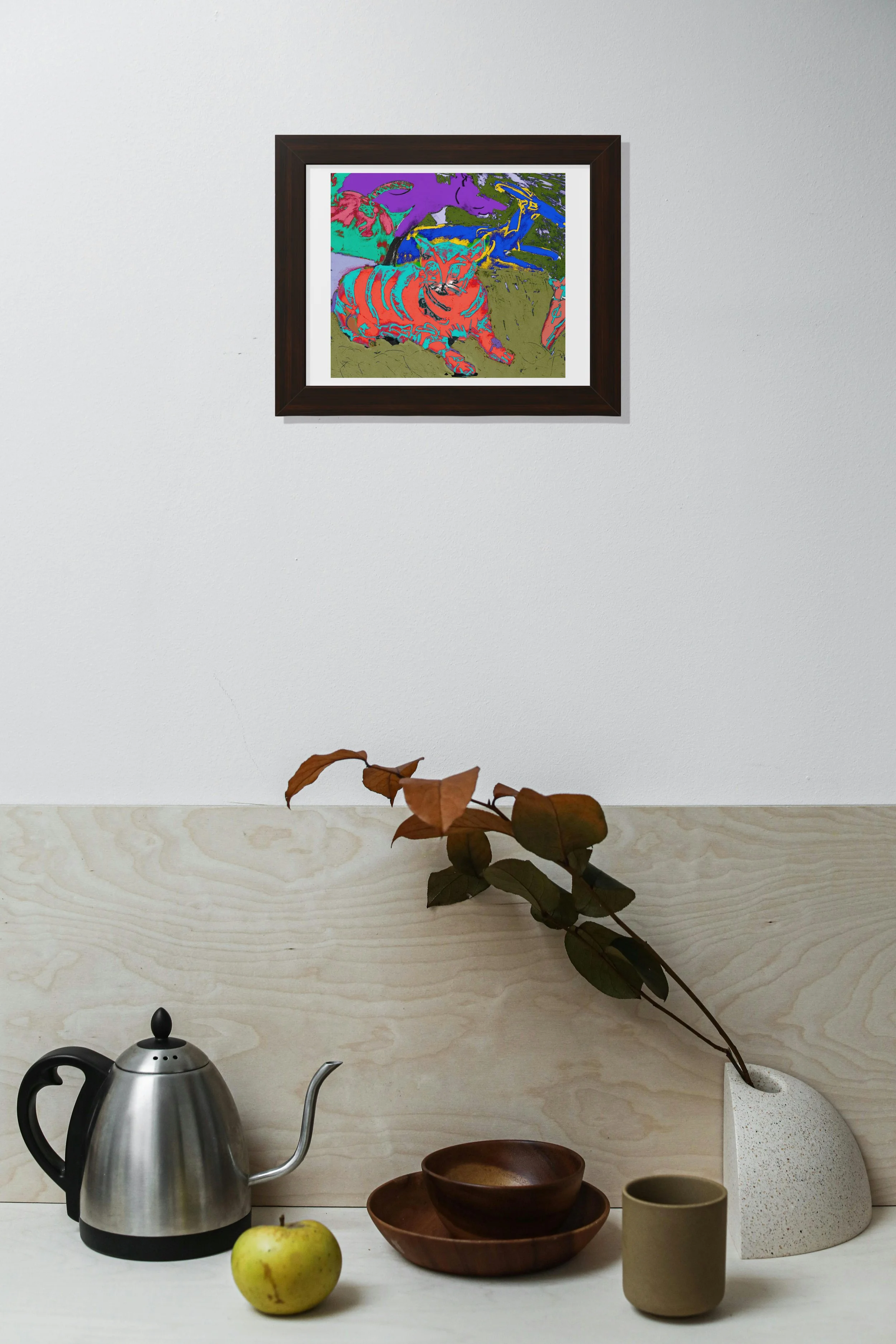Colorful cat art print framed in black with a matte.  hang above a kitchen table with dried leaves and tea pot.
