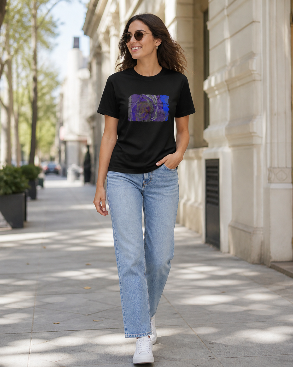 female model wearing black t-shirt of vivid shades of purple, blue, gold, and charcoal abstract art
