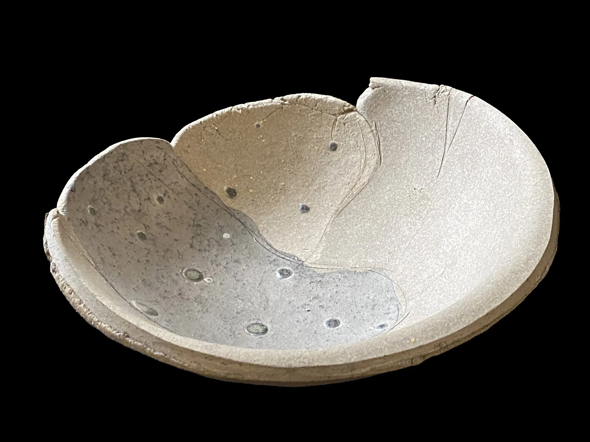 Large yakishime unglazed stoneware bowl with organic ash textures and softly irregular rim, displayed under gallery lighting