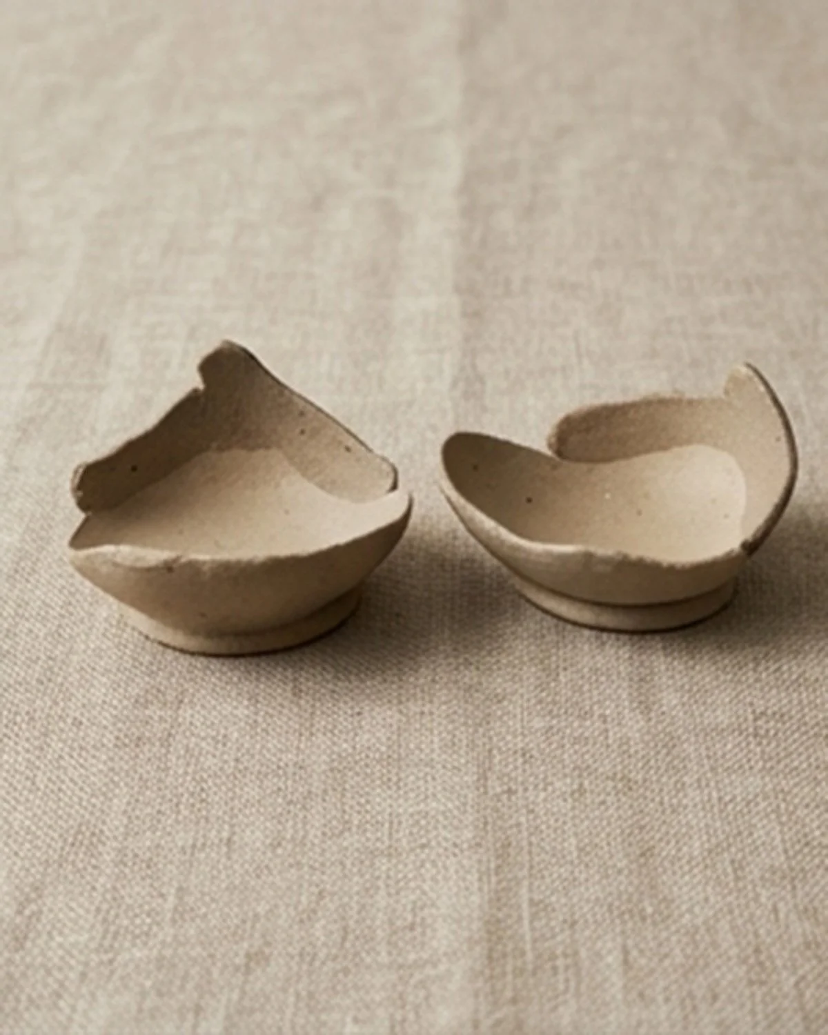 Handmade yakishime unglazed stoneware bowl with shallow form and organic asymmetry