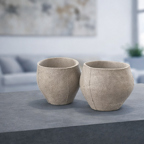Set of yakishime unglazed stoneware cups displayed on a white pedestal in a minimalist gallery setting