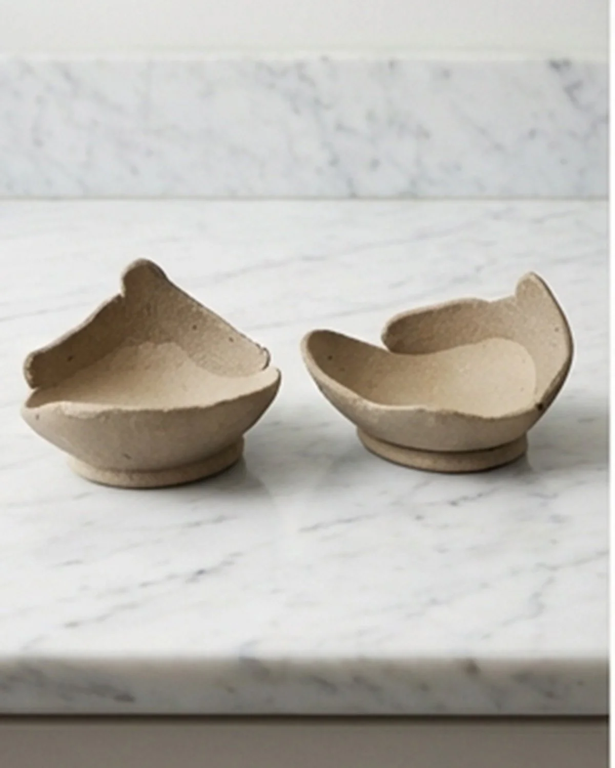 Handmade yakishime unglazed stoneware bowl with shallow form and organic asymmetry