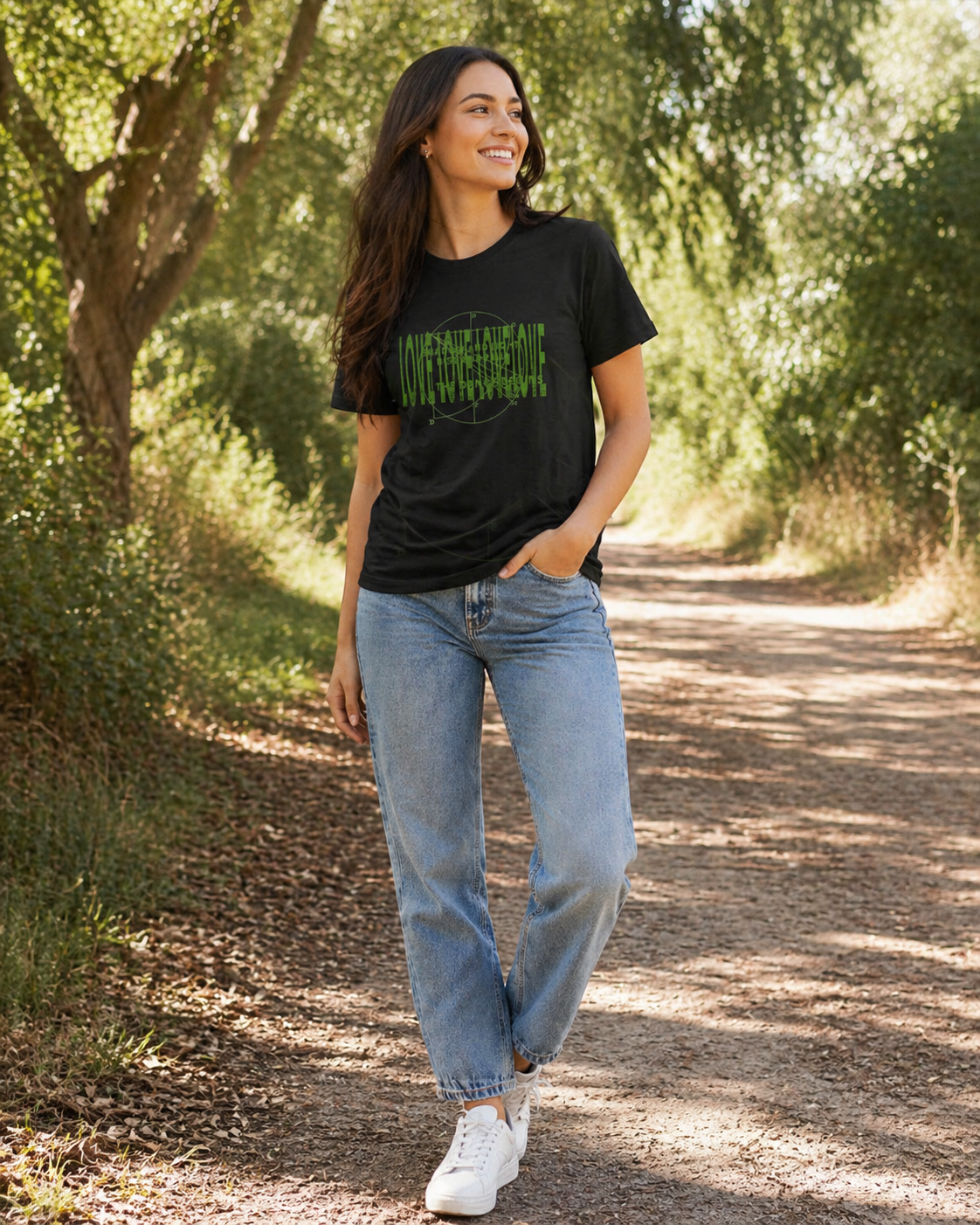 Crew neck black t-shirt with a green texts and circular overlaid graphic design. A woman walking on an urban street.