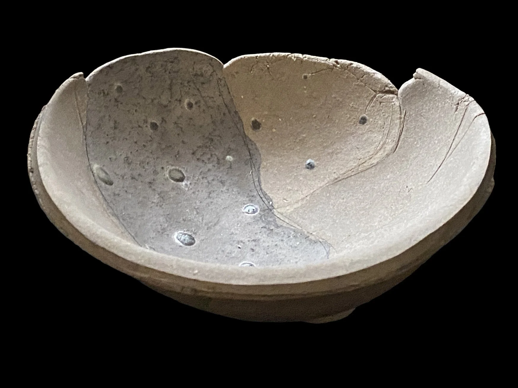 Large yakishime unglazed stoneware bowl with organic ash textures and softly irregular rim, displayed under gallery lighting