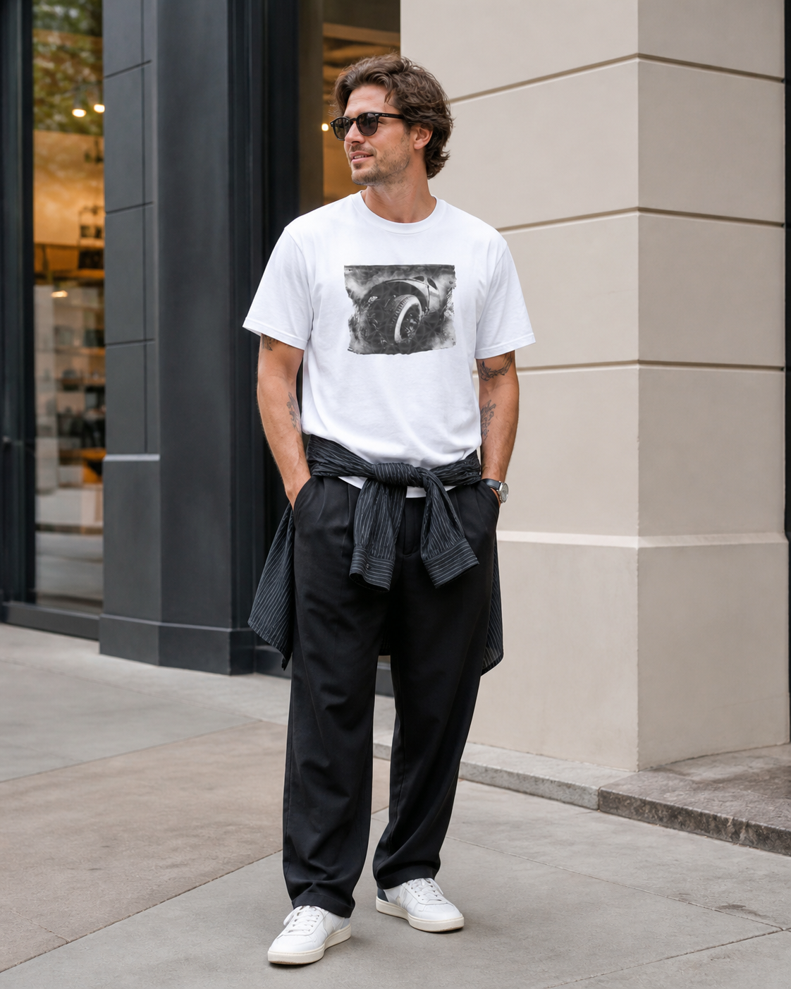 Male model wearing monochrome automotive wheel art graphic on white t-shirt