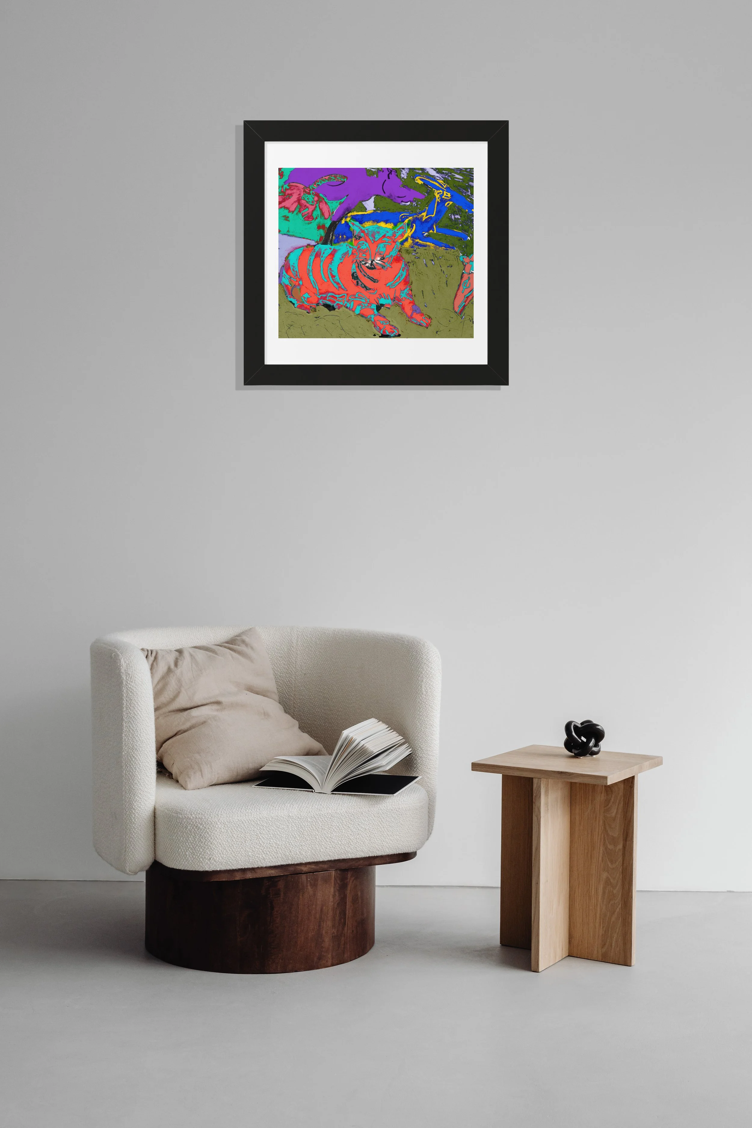 A framed art print featuring a colorful abstract illustration of a cat. The cat is depicted in shades of red and orange with striped patterns. The background includes purple, green, and blue hues.