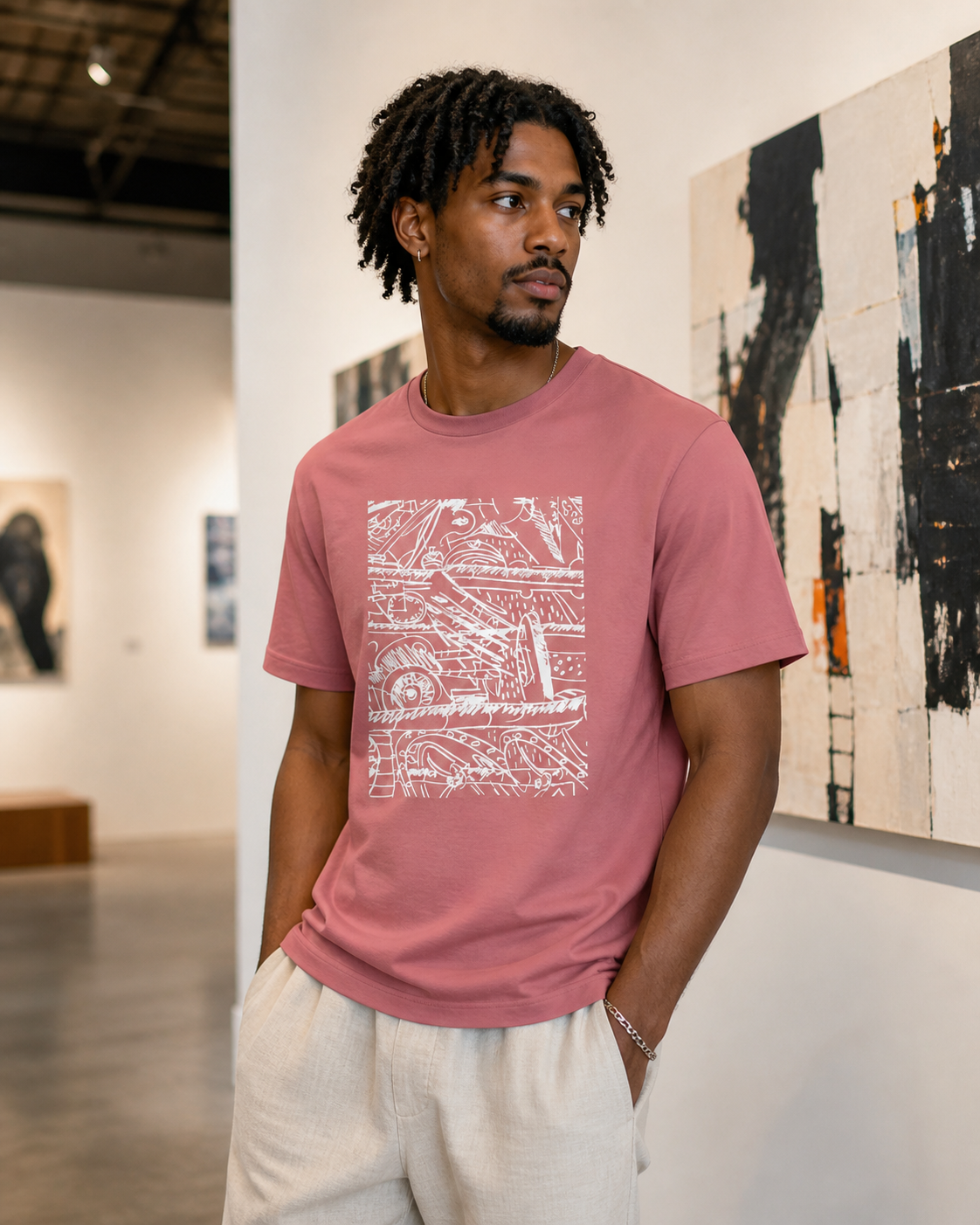 Male model wearing a mauve t-shirt featuring a white abstract design. The graphic is a complex arrangement of lines, shapes, and numbers.